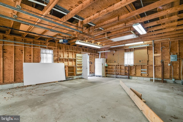 garage with white fridge and a garage door opener