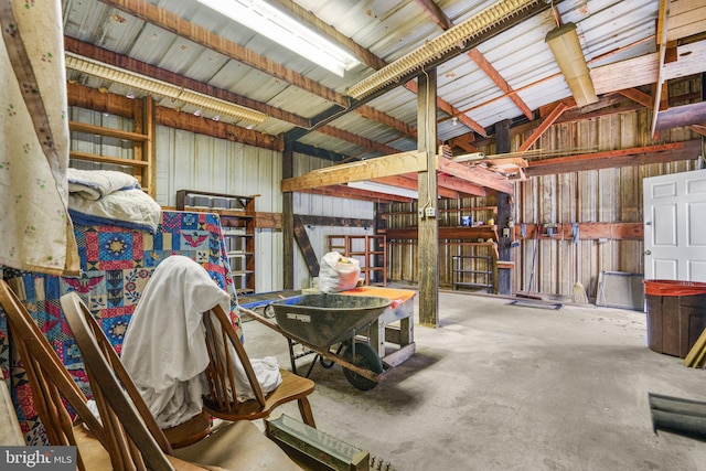 miscellaneous room with concrete floors and lofted ceiling