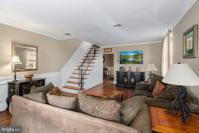 living room with dark hardwood / wood-style flooring and crown molding