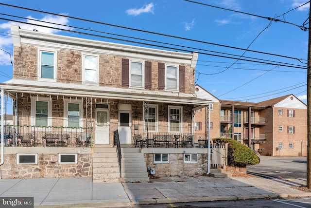 townhome / multi-family property featuring covered porch