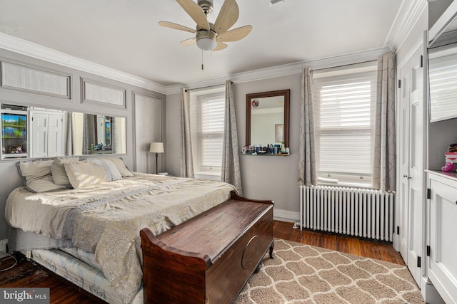 bedroom with ceiling fan, dark hardwood / wood-style flooring, radiator heating unit, and ornamental molding