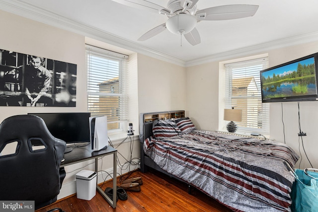 bedroom featuring dark hardwood / wood-style floors, ceiling fan, and ornamental molding