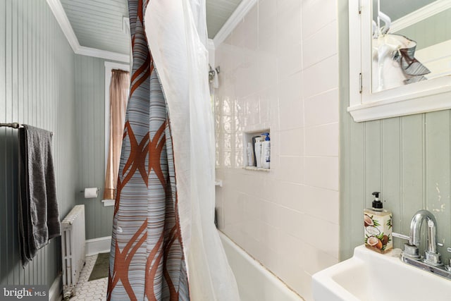 bathroom with radiator heating unit, shower / bath combination with curtain, ornamental molding, and sink