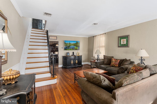 living room with dark hardwood / wood-style flooring and ornamental molding