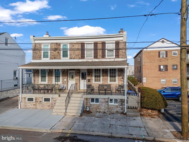 view of property featuring covered porch