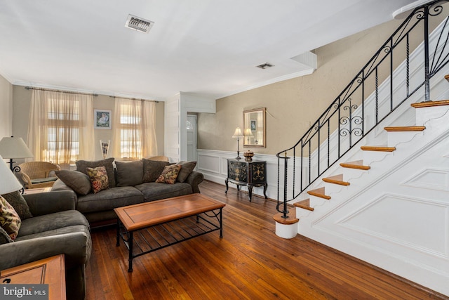 living room with dark hardwood / wood-style flooring and crown molding