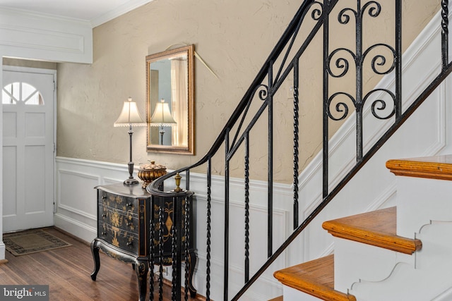 foyer entrance with hardwood / wood-style floors and ornamental molding