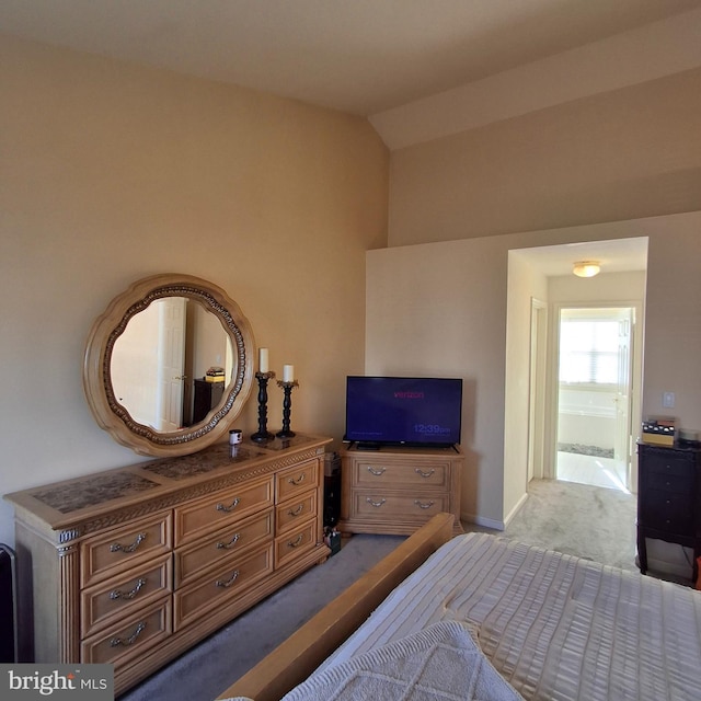 carpeted bedroom with vaulted ceiling