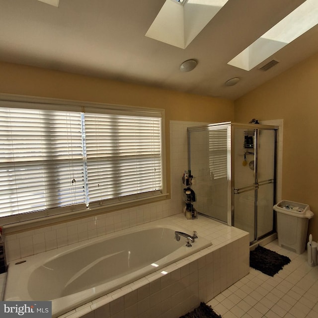 bathroom featuring tile patterned floors, plus walk in shower, and vaulted ceiling with skylight