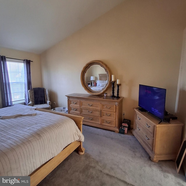 bedroom featuring light carpet and lofted ceiling