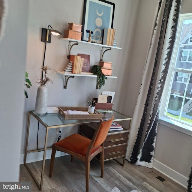 office space featuring hardwood / wood-style floors and a healthy amount of sunlight