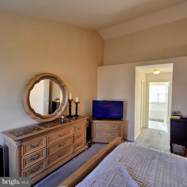 carpeted bedroom with lofted ceiling