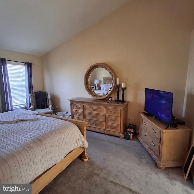 bedroom featuring lofted ceiling and light colored carpet