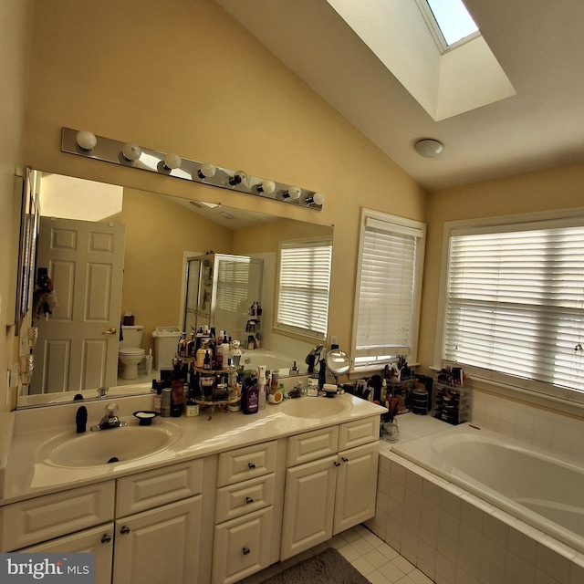 full bathroom with toilet, vanity, independent shower and bath, vaulted ceiling with skylight, and tile patterned flooring