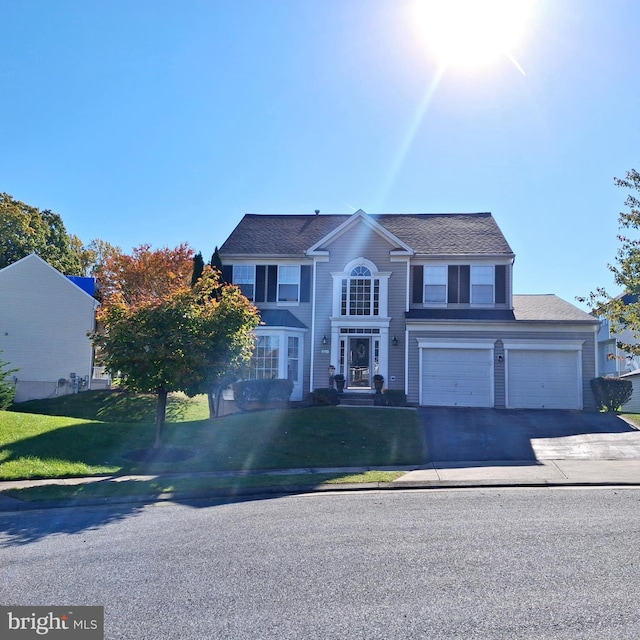 view of front of house with a garage and a front yard