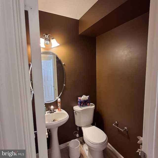 bathroom featuring sink and toilet