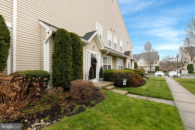 view of home's exterior with a lawn