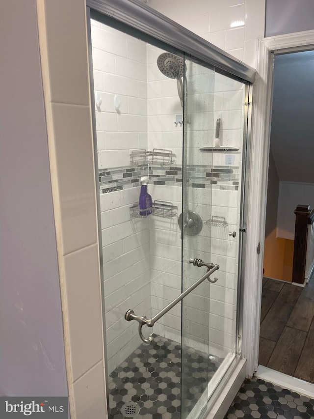 bathroom with a shower with shower door