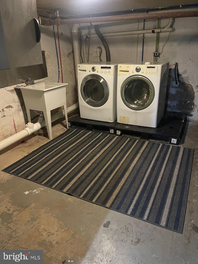 laundry room with separate washer and dryer and sink