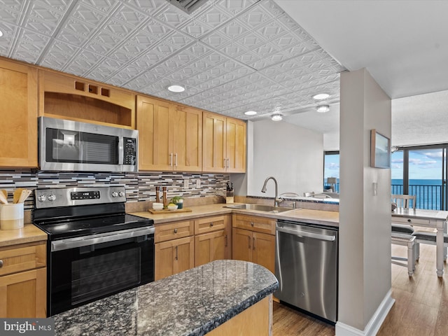 701 S Edgewater House Rd Unit 701S, Bethany Beach, DE 19930 - kitchen featuring stainless steel appliances, tasteful backsplash, wood finished floors, an ornate ceiling, and open shelves