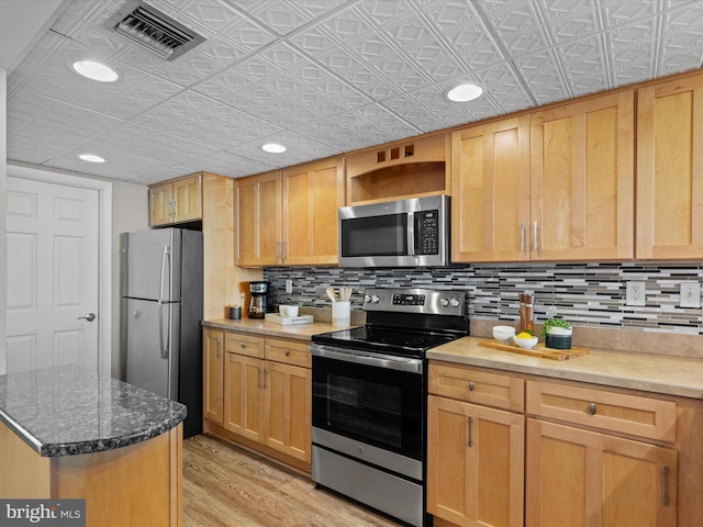 701 S Edgewater House Rd Unit 701S, Bethany Beach, DE 19930 - kitchen with appliances with stainless steel finishes, an ornate ceiling, backsplash, light wood-style floors, and light brown cabinets