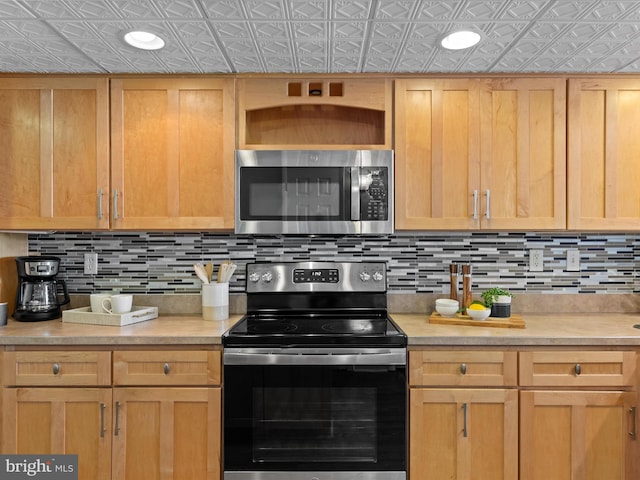 701 S Edgewater House Rd Unit 701S, Bethany Beach, DE 19930 - kitchen with appliances with stainless steel finishes, an ornate ceiling, decorative backsplash, light countertops, and light brown cabinets