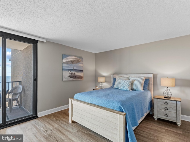 701 S Edgewater House Rd Unit 701S, Bethany Beach, DE 19930 - bedroom featuring wood finished floors, access to outside, and a textured ceiling