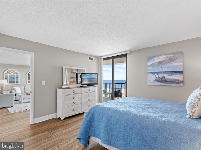 701 S Edgewater House Rd Unit 701S, Bethany Beach, DE 19930 - bedroom featuring access to outside, wood finished floors, and a textured ceiling