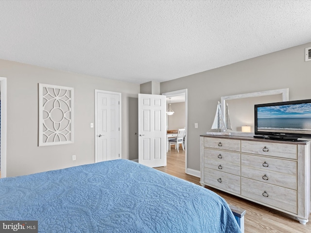 701 S Edgewater House Rd Unit 701S, Bethany Beach, DE 19930 - bedroom with wood finished floors and a textured ceiling