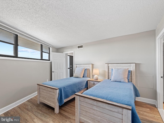701 S Edgewater House Rd Unit 701S, Bethany Beach, DE 19930 - bedroom featuring wood finished floors and a textured ceiling