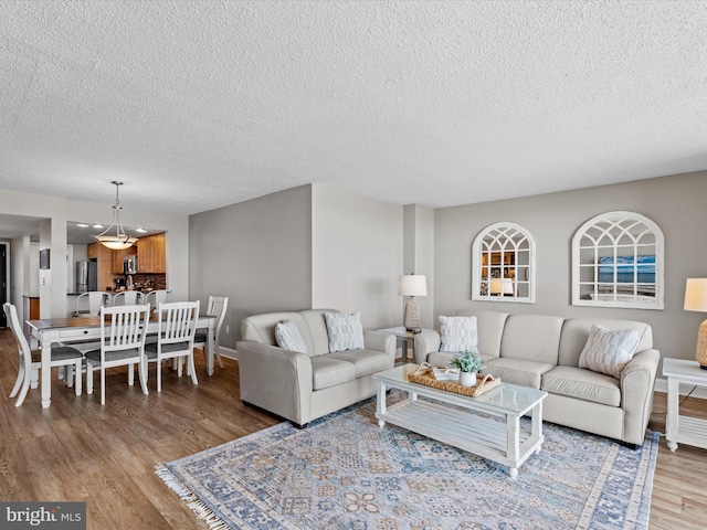 701 S Edgewater House Rd Unit 701S, Bethany Beach, DE 19930 - living area with wood finished floors, a textured ceiling, and a chandelier