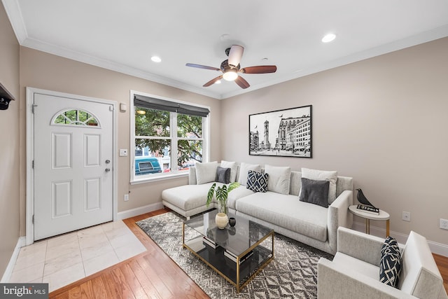 living room with hardwood / wood-style floors, ceiling fan, and crown molding