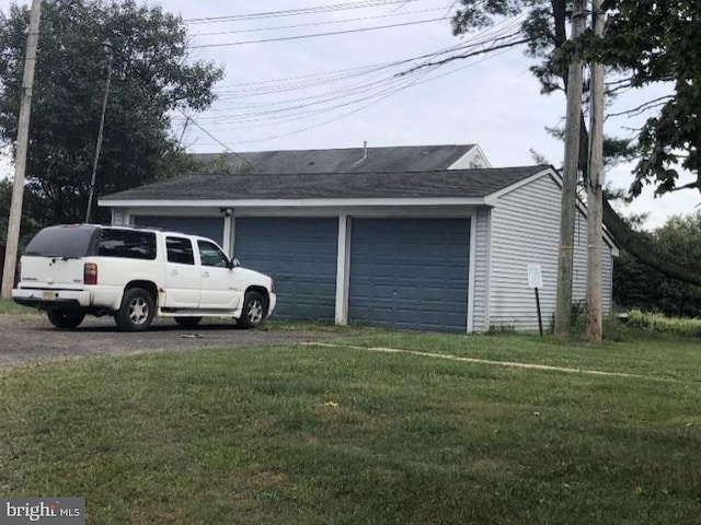 garage featuring a lawn