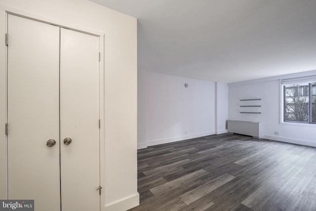 unfurnished living room featuring dark hardwood / wood-style floors