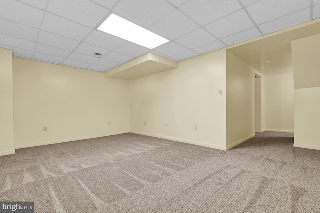 empty room featuring a drop ceiling and carpet floors