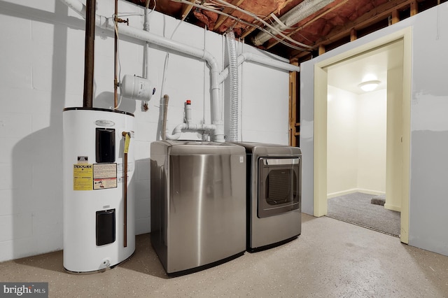 laundry room featuring water heater and washing machine and clothes dryer