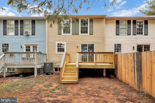 rear view of house featuring a wooden deck and central AC unit