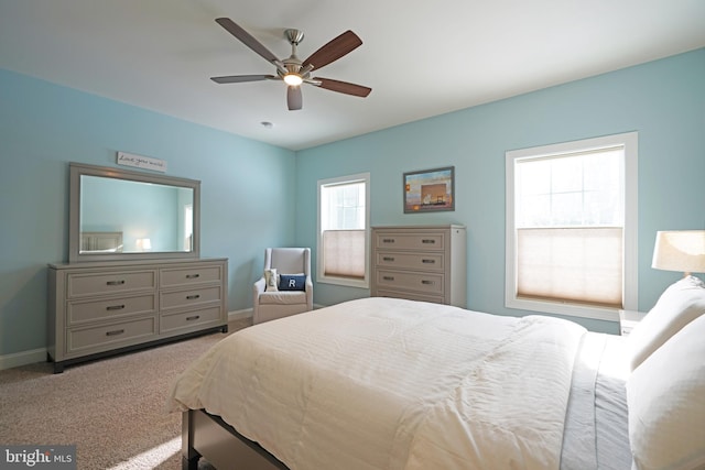 bedroom featuring ceiling fan and light carpet