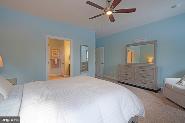 carpeted bedroom featuring ceiling fan and ensuite bathroom