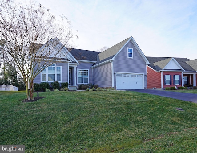 view of front of property with a front yard and a garage