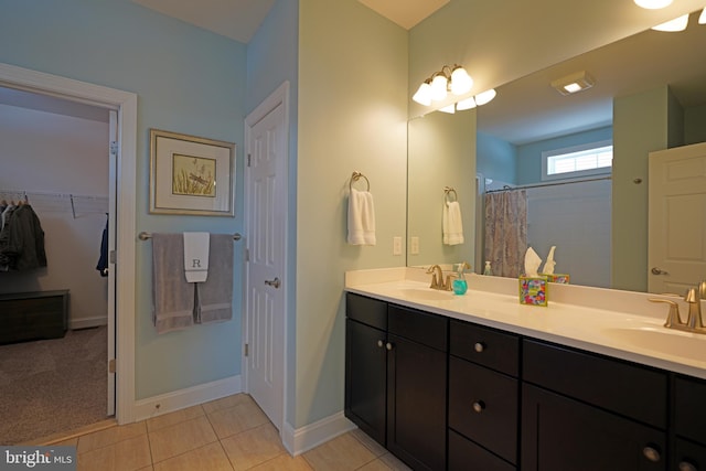 bathroom with tile patterned floors, vanity, and walk in shower