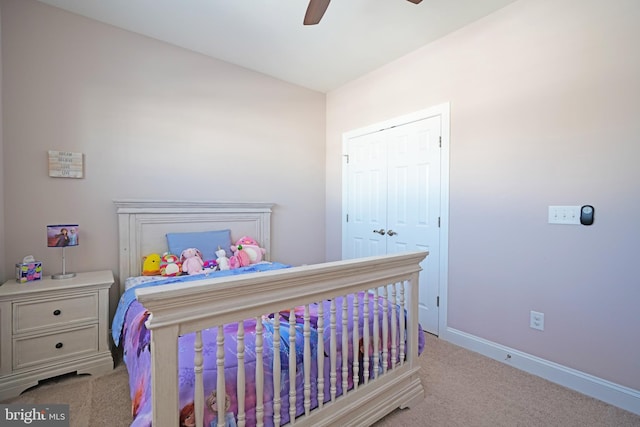 bedroom with ceiling fan, light colored carpet, and a closet