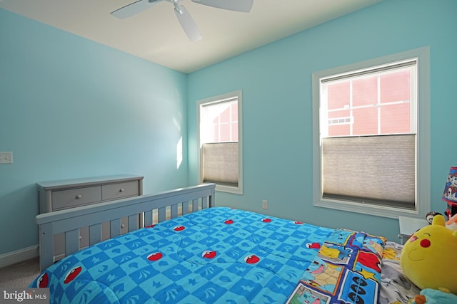 bedroom featuring carpet, ceiling fan, and multiple windows