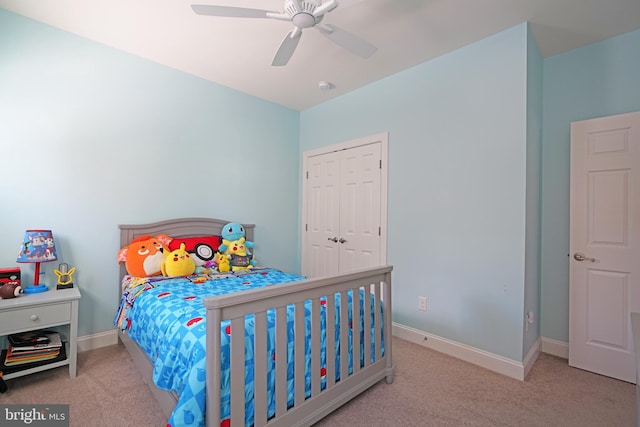 carpeted bedroom featuring a closet and ceiling fan