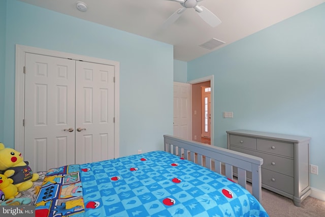 carpeted bedroom featuring a closet and ceiling fan