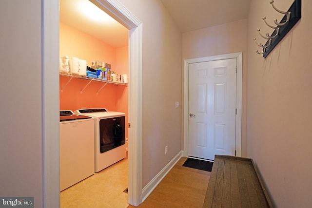 washroom featuring washer and clothes dryer and light wood-type flooring