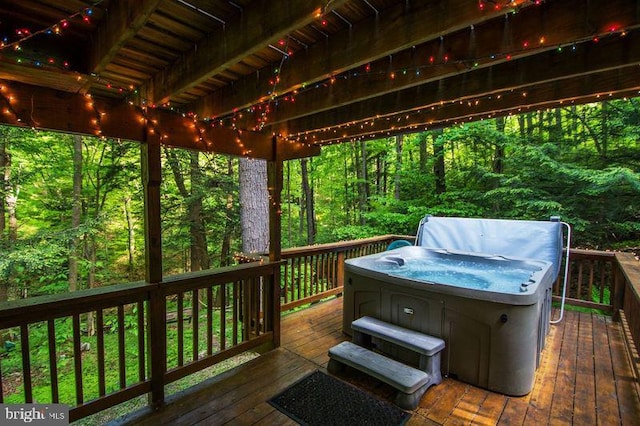 wooden deck featuring a hot tub