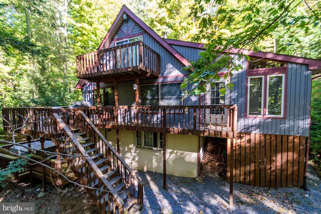 back of property with a wooden deck