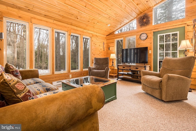 living room with carpet flooring, wooden walls, wood ceiling, and a wealth of natural light