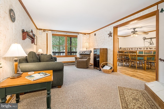 living room with crown molding, ceiling fan, wood-type flooring, and a baseboard radiator